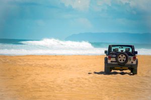 Offroad Vehicle on sand at a Remote Beach in Hawaii